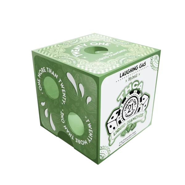 A cubic packaging box in green and white, labeled "THCA Liquid Diamonds," adorned with dice imagery and intricate patterns. The box features circular cutouts, the text "MORE THAN TWENTY ONE" along the edges, and "Laughing Gas 3ML THCa Diamonds Disposable Vape" branding on the top.