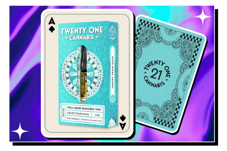 A Twenty One Cannabis Ghost Train Haze vape cartridge pack with a set of playing cards against a colorful background