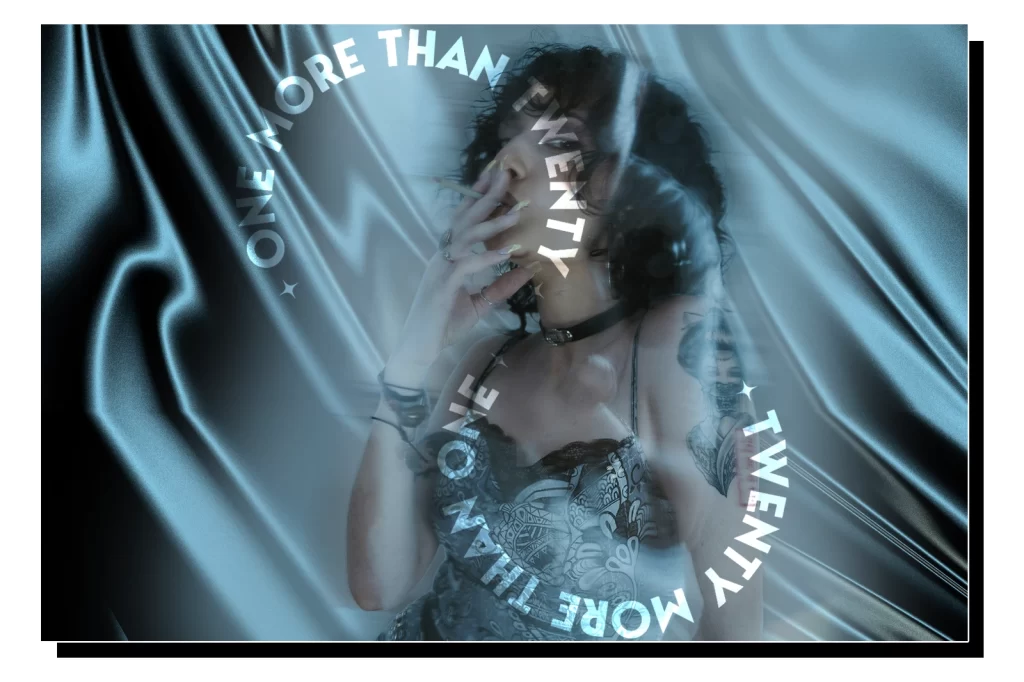 A lady holds a pre-roll between her lips and exhales smoke