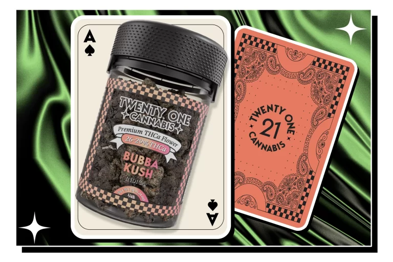 A Twentyone Cannabis Bubba Kush THCa flower displayed alongside two playing cards, set against a glossy cloth background