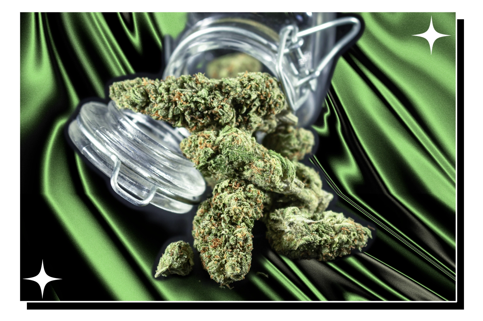 Cannabis buds spill from a glass jar onto a vibrant green silky cloth
